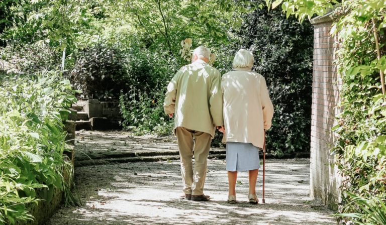 Two elderly people walking