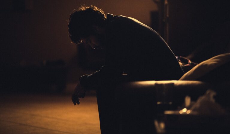 Man sitting forlornly in the dark