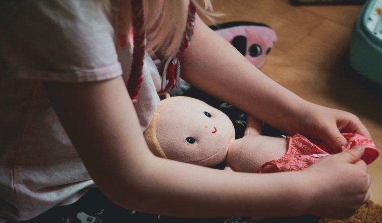 Child playing with doll