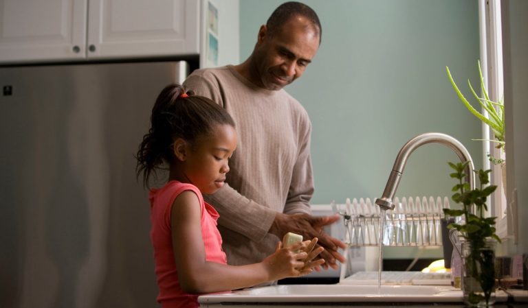 Father and daughter washing hands