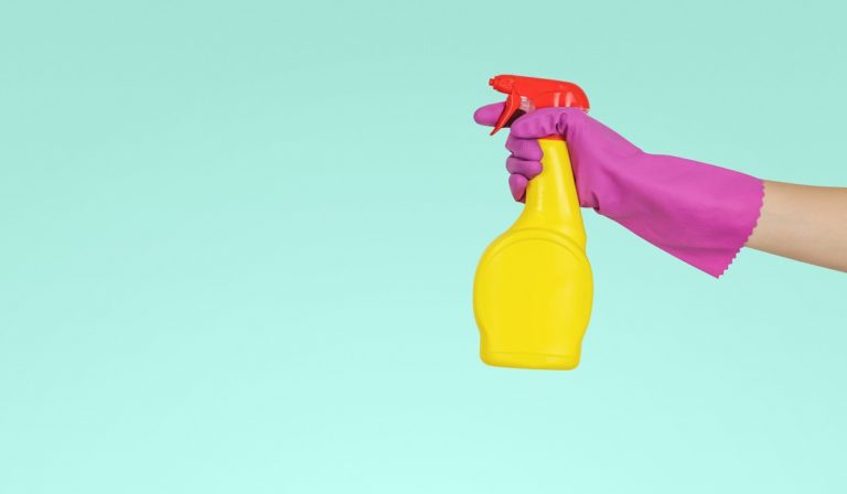 Bottle spray with gloved hand