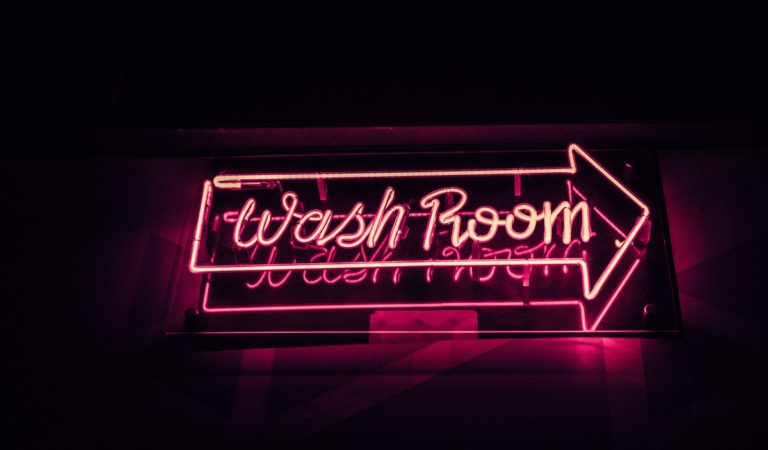 Neon pink "Wash Room" sign