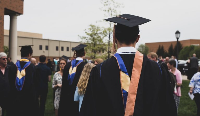 Man graduating (from behind)