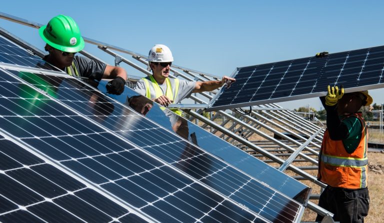 Workers installing solar panels