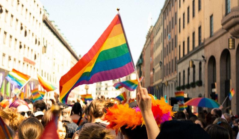 Waving pride flag in crowd