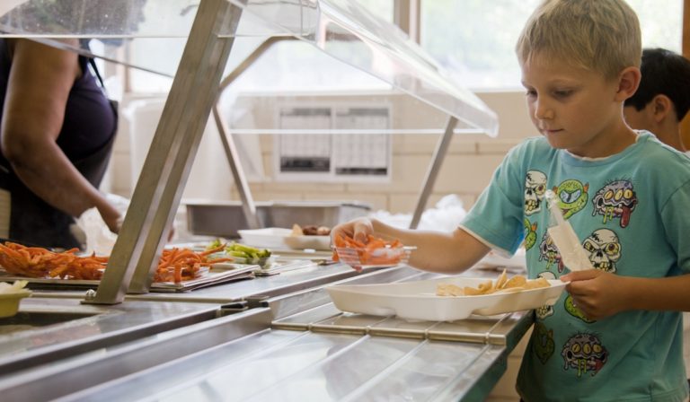 Child getting cafeteria lunch