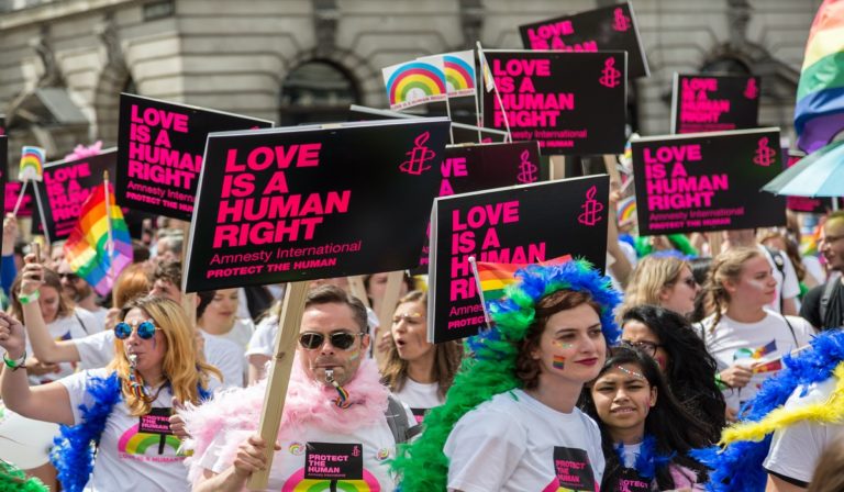 A group of people participate in LGBTQ March