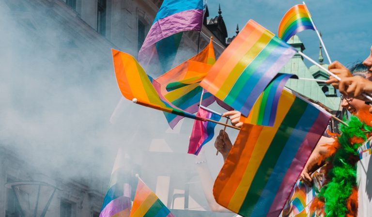 A group of people holding pride flag