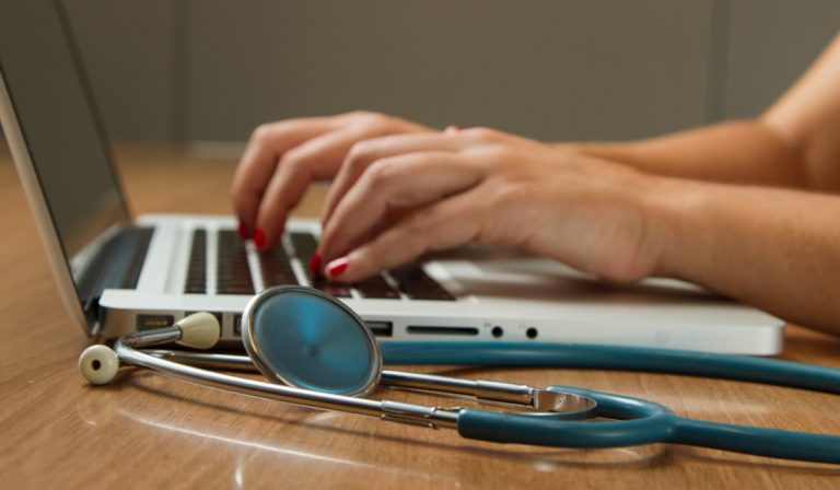 Hands at keyboard with stethoscope