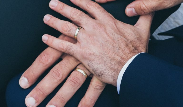 Two men's hands with rings on them