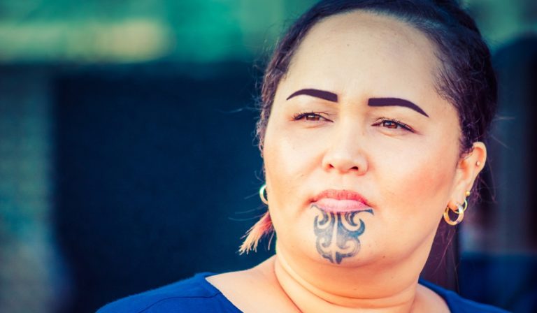 Close up portrait of a Maori business woman outdoors in the workplace.