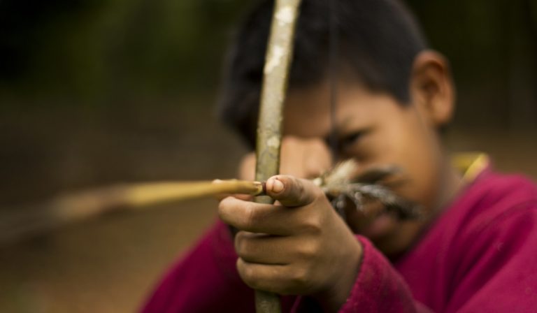 Guarani child holding bow