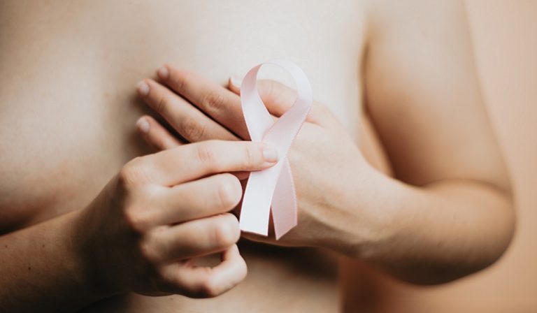 Woman with pink breast cancer ribbon