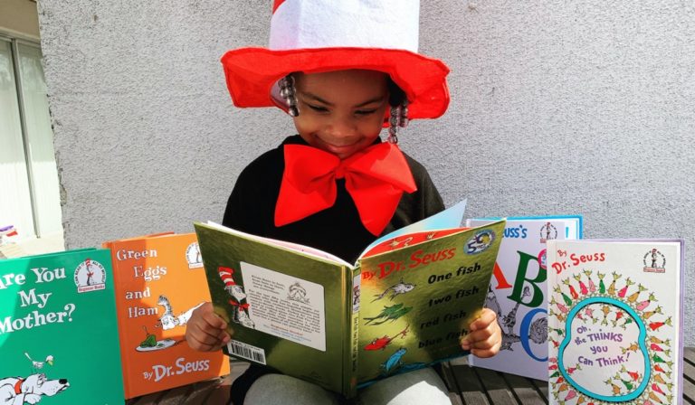 Child reading Dr. Seuss books