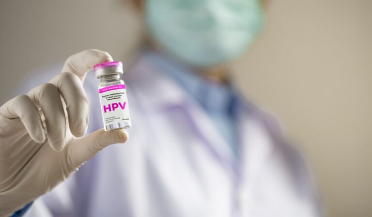 Doctor holding vial of HPV vaccine