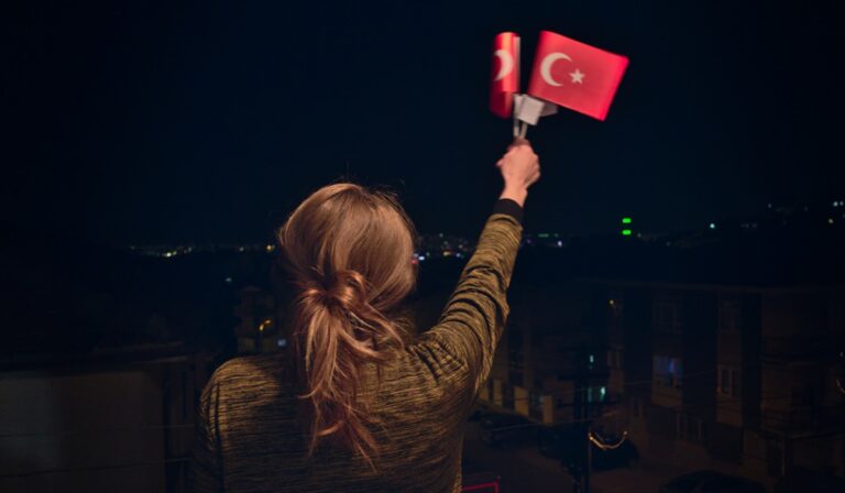 Woman holding Turkish flags