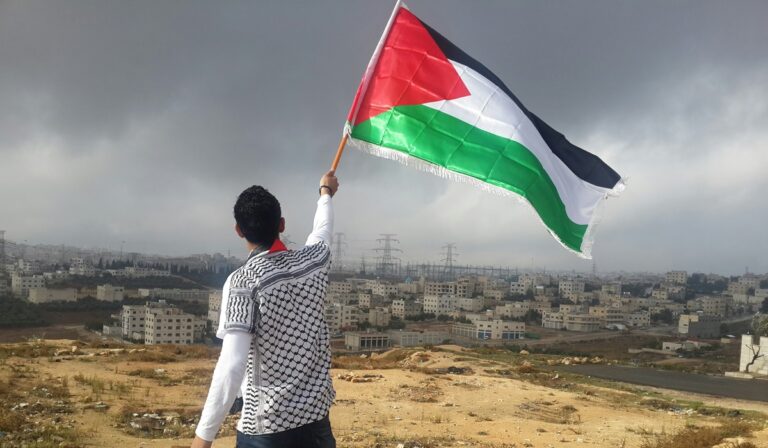Man holding Palestinian flag