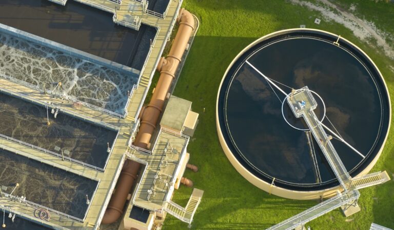 Aerial view of modern water cleaning facility at urban wastewater treatment plant. Purification process of removing undesirable chemicals, suspended solids and gases from contaminated liquid