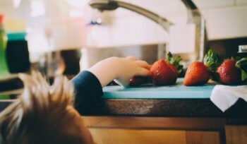 Child taking a strawberry