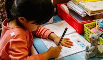 Child with pen and paper