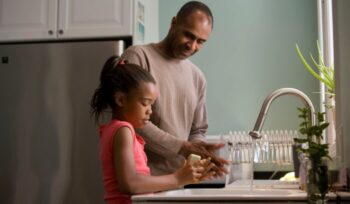 Father and daughter washing hands