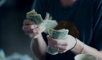 Hands counting money|sharon mccutcheon unsplash