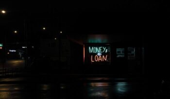 Money to Loan neon sign in dark street|Mt Rushmore