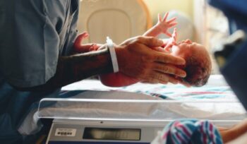 Newborn baby being held