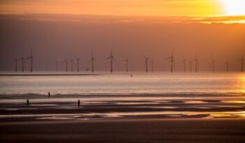 Offshore wind turbines at sunset