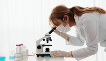 Researcher looking through microscope