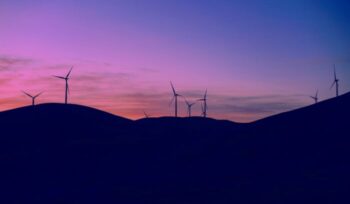 Silhouette of wind turbines at dusk|Wind Hydro