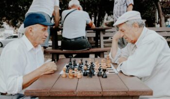 Two elderly men playing chess