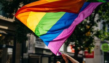 Waving a pride flag|Gay flag