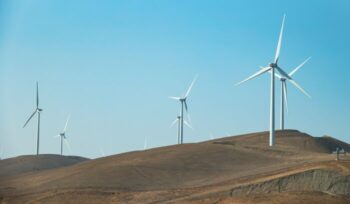 Wind turbines on dry hill|rawfilm unsplash