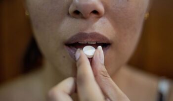 Woman eating pill